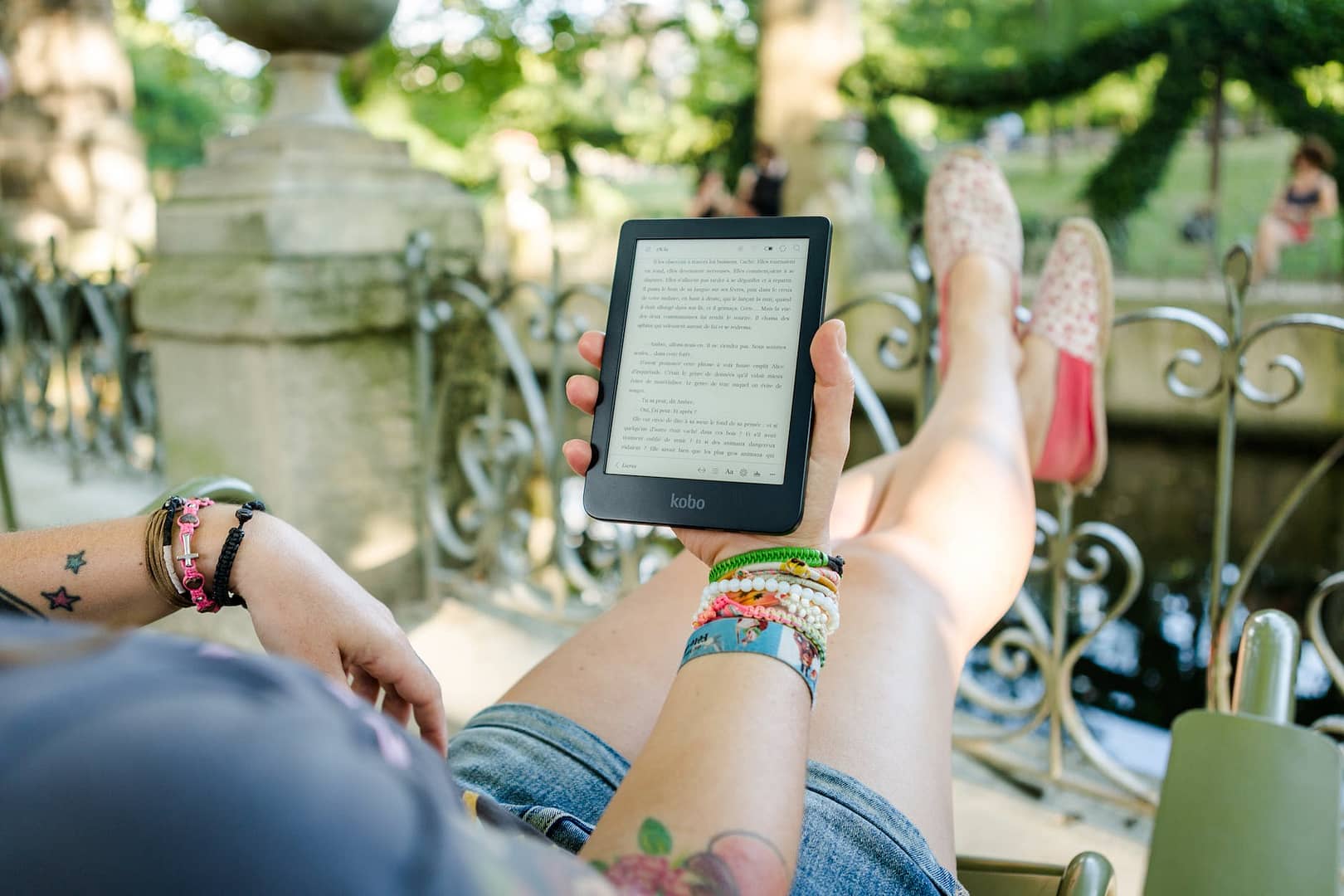 person holding person holding kobo e reader - Midas Word Reader Survey
