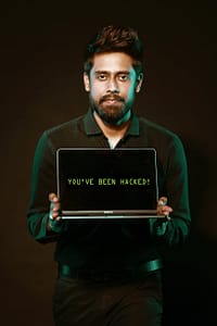 man holding laptop computer with both hands
