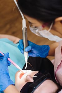 a person holding dental equipment
