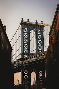 old brooklyn bridge under white sky at sunset