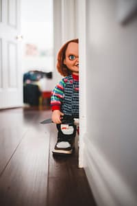 doll with knife in trendy gumshoe at home