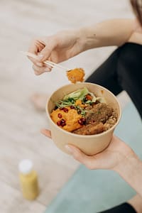 person holding a bowl of food