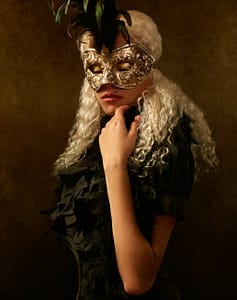 alluring woman in carnival mask and eyes closed