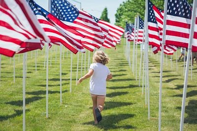 child running among american flags