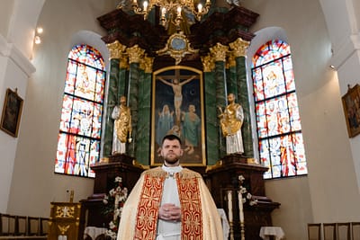priest standing in front of the altar