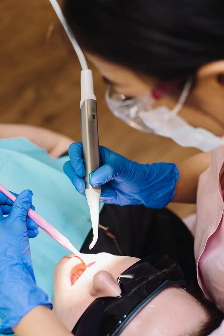 a person holding dental equipment - My teeth: deep roots into psyche