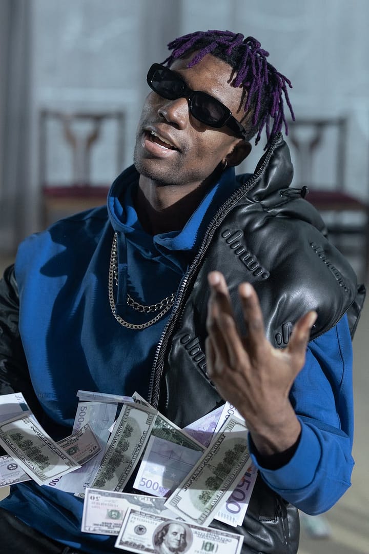 a man in blue jacket wearing sunglasses