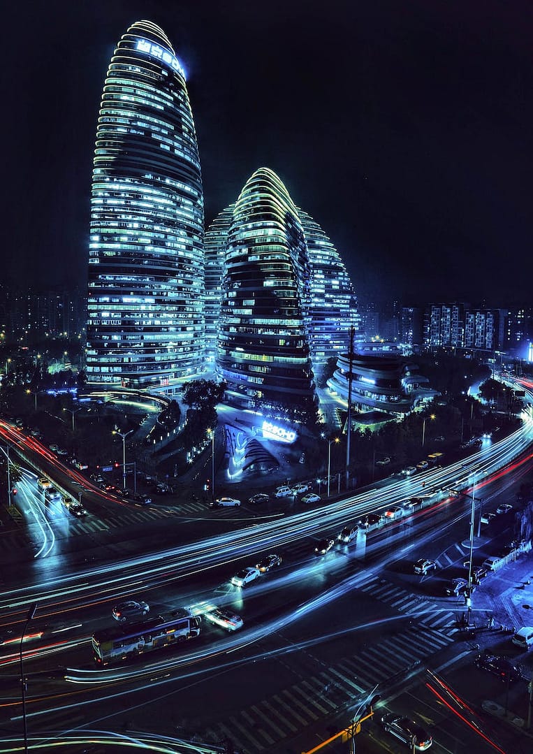 moving cars on the road near wangjing soho buildings