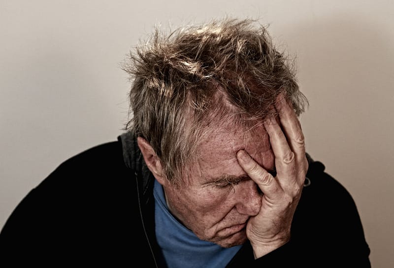 man holding his face The Royal Commission into the Robodebt Scheme